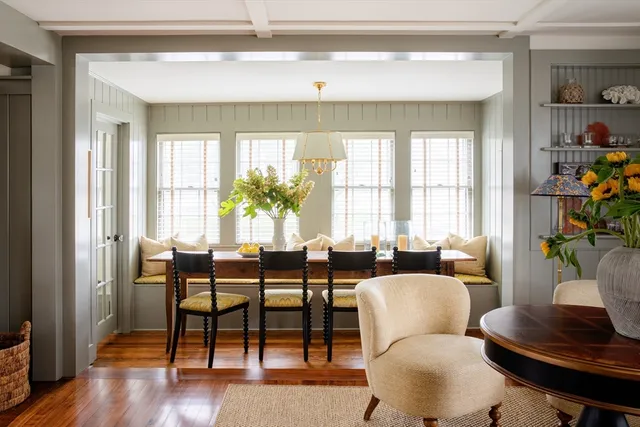 a dining room with furniture and wooden floor