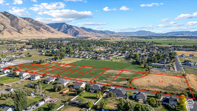294 West 3400 South, Unit 9 Logan, UT 84321 - Photo 18 of 24 Aerial perspective of suburban area with property parcel outlined and a mountainous background