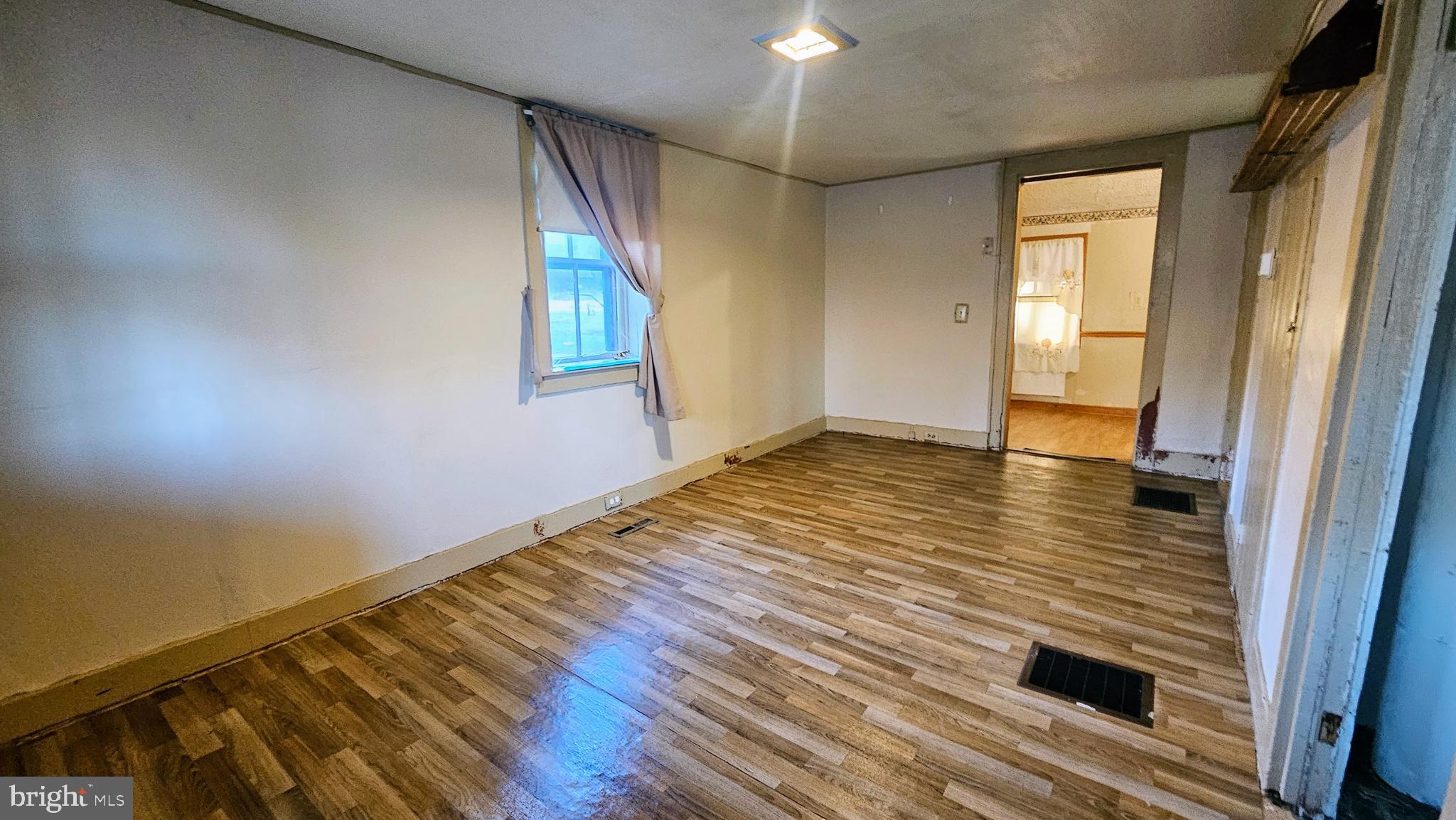 1535 Erney Road Dover, PA 17315 - Photo 16 of 20 a view of an empty room with wooden floor and a window