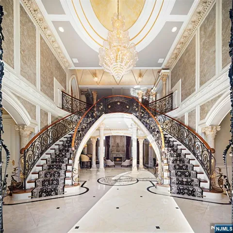 a living room with furniture floor to ceiling window and wooden floor