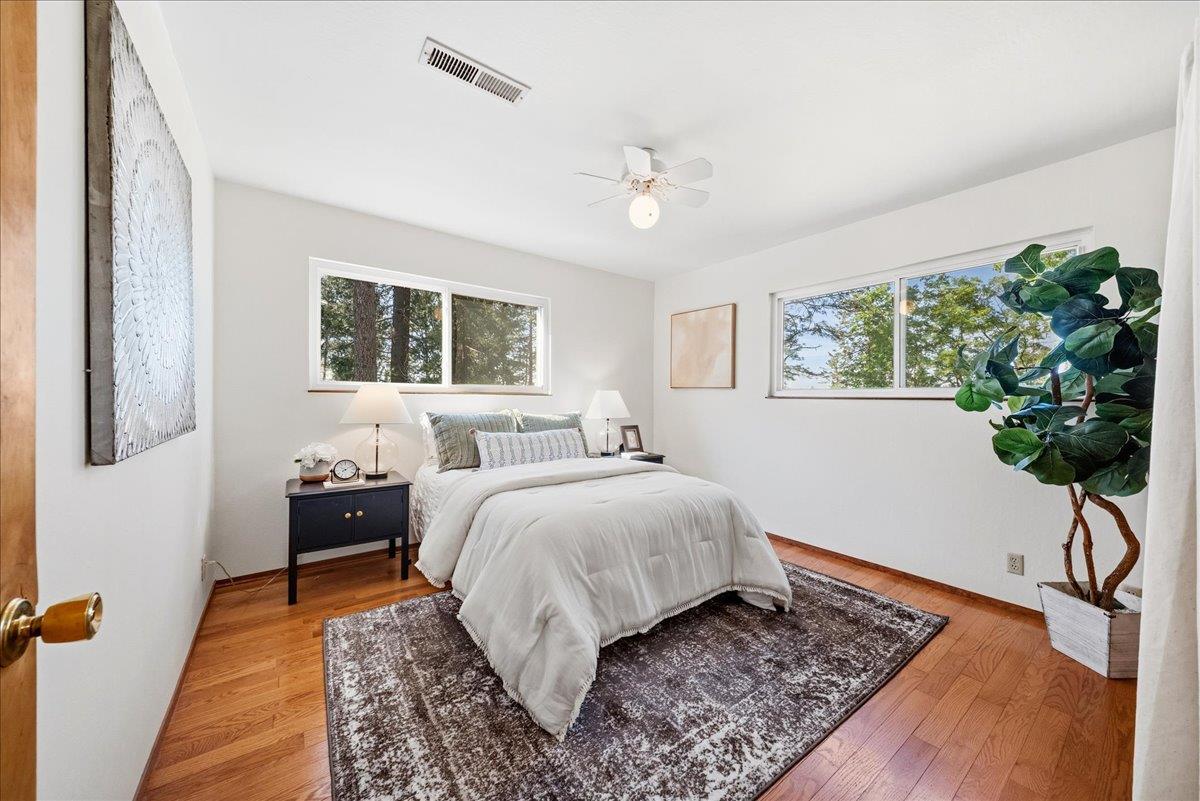 21465 Mason Road Colfax, CA 95713 - Photo 9 of 33 a bedroom with a large bed and a potted plant