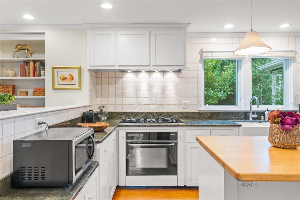 167 Court Street Dedham, MA 02026 - Photo 16 of 42 a kitchen with stainless steel appliances granite countertop a stove a sink and a microwave
