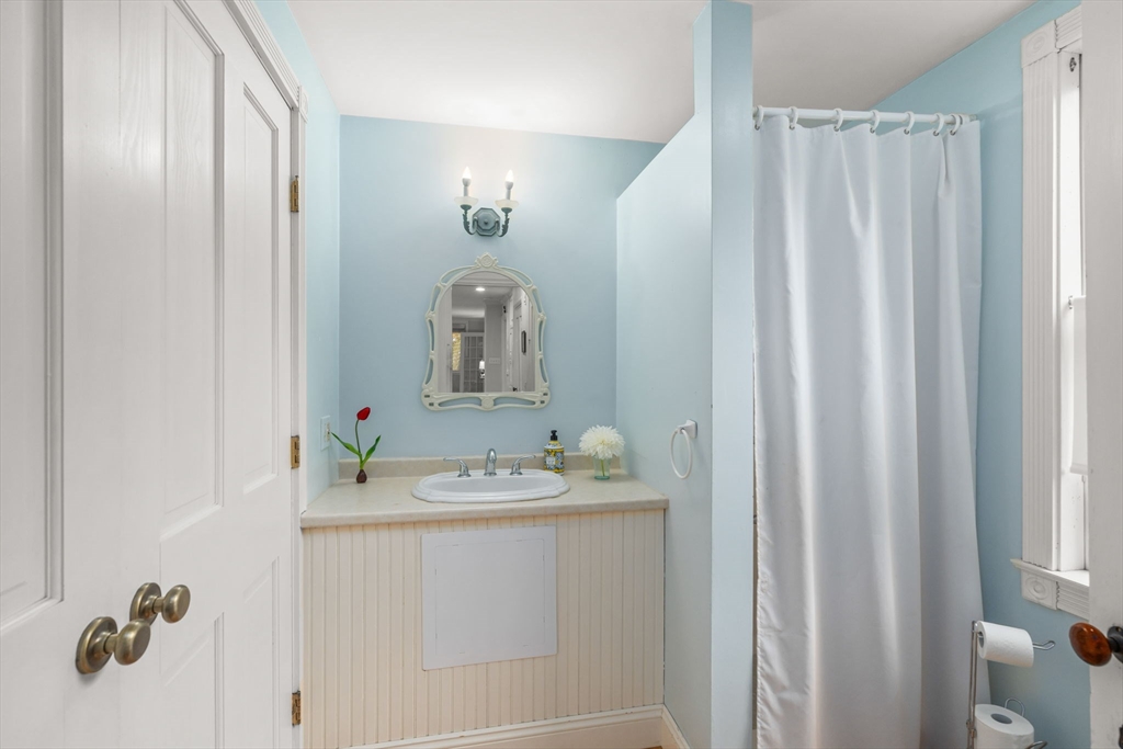 167 Court Street Dedham, MA 02026 - Photo 19 of 42 a bathroom with a sink vanity and tub