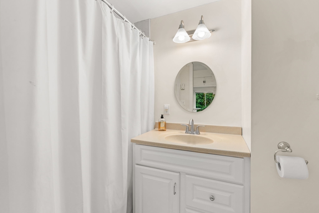 167 Court Street Dedham, MA 02026 - Photo 24 of 42 a bathroom with a sink and a mirror