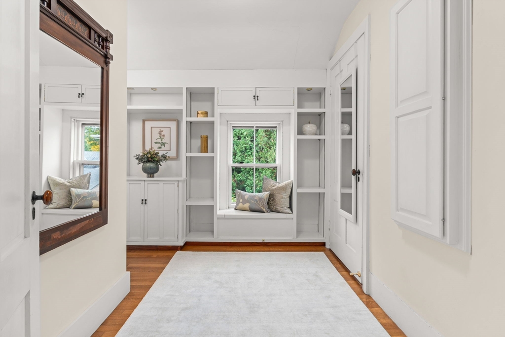 167 Court Street Dedham, MA 02026 - Photo 26 of 42 a view of a hallway with wooden floor and a living room