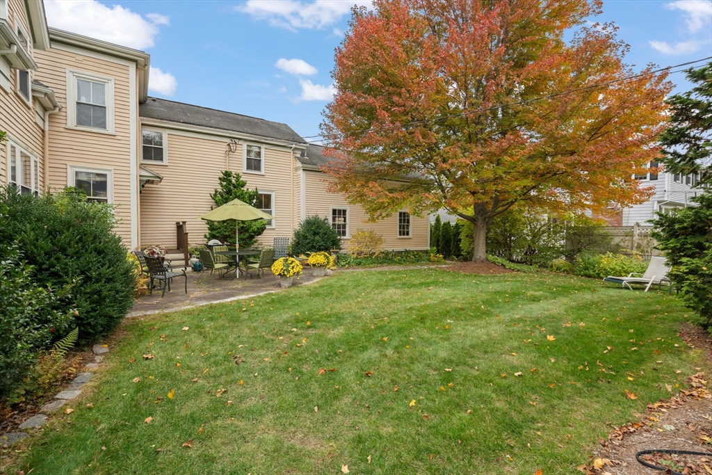 167 Court Street Dedham, MA 02026 - Photo 38 of 42 a backyard of a house with table and chairs