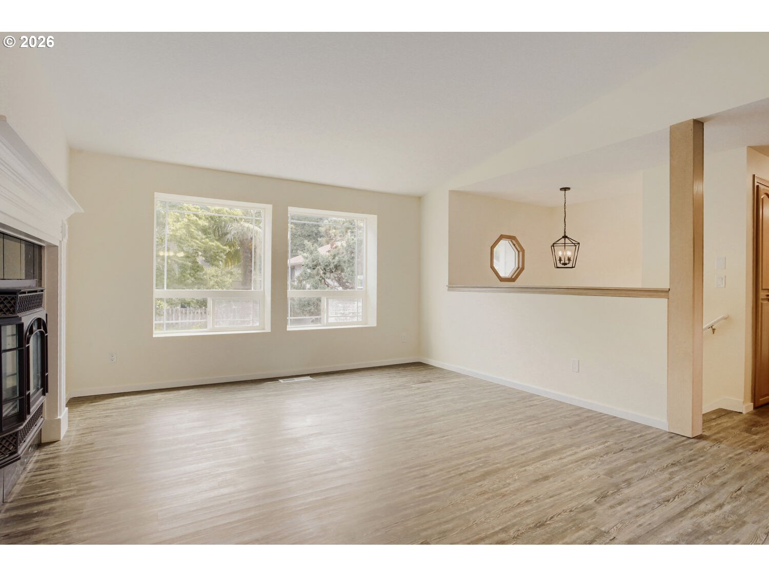 14539 Southeast Center Street Portland, OR 97236 - Photo 6 of 30 a view of an empty room with wooden floor and a window