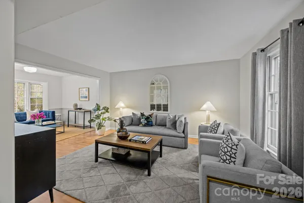 a living room with furniture and wooden floor