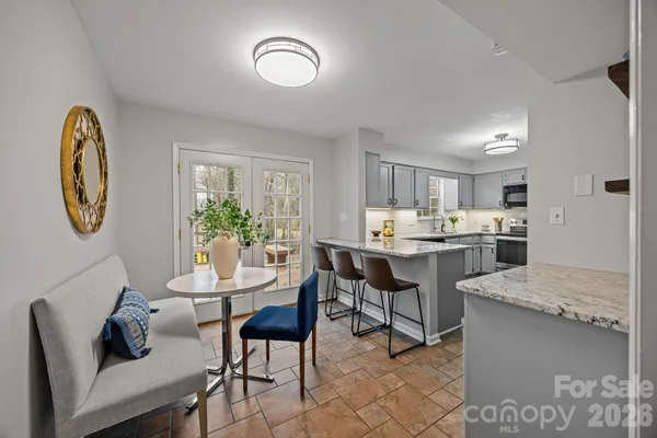 a living room with kitchen island furniture and a table