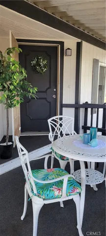 a table with chairs and a potted plant