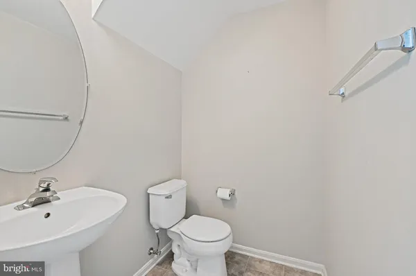 a living room with furniture a fireplace and a dining table with wooden floor