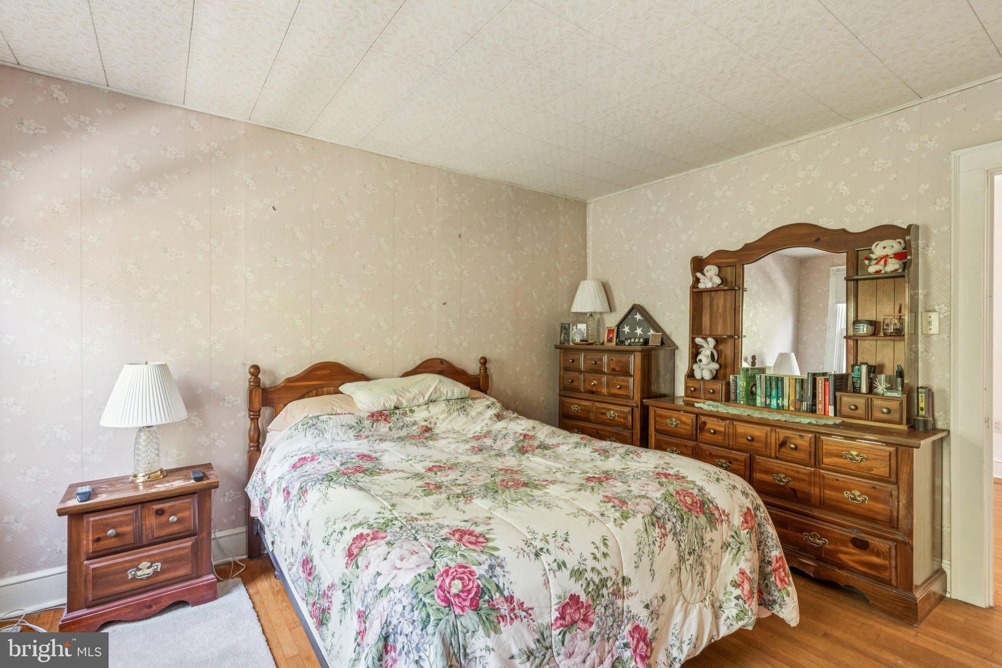 375 Church Road Jenkintown, PA 19046 - Photo 45 of 69 a bedroom with a bed and a dresser with mirror