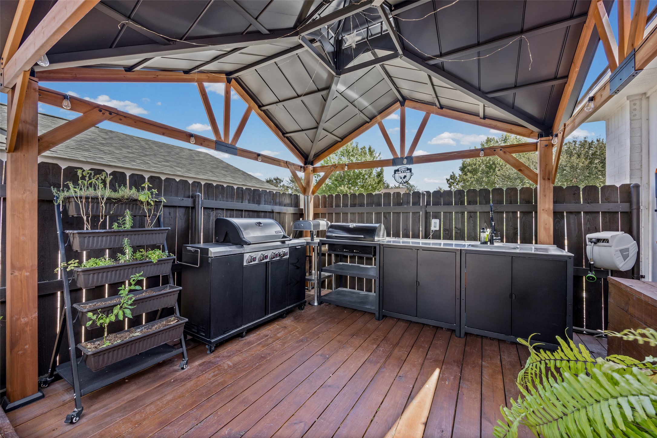 3006 Overland Street Round Rock, TX 78681 - Photo 20 of 29 A handsome wood-framed pavilion covers this outdoor kitchen set on a spacious deck.