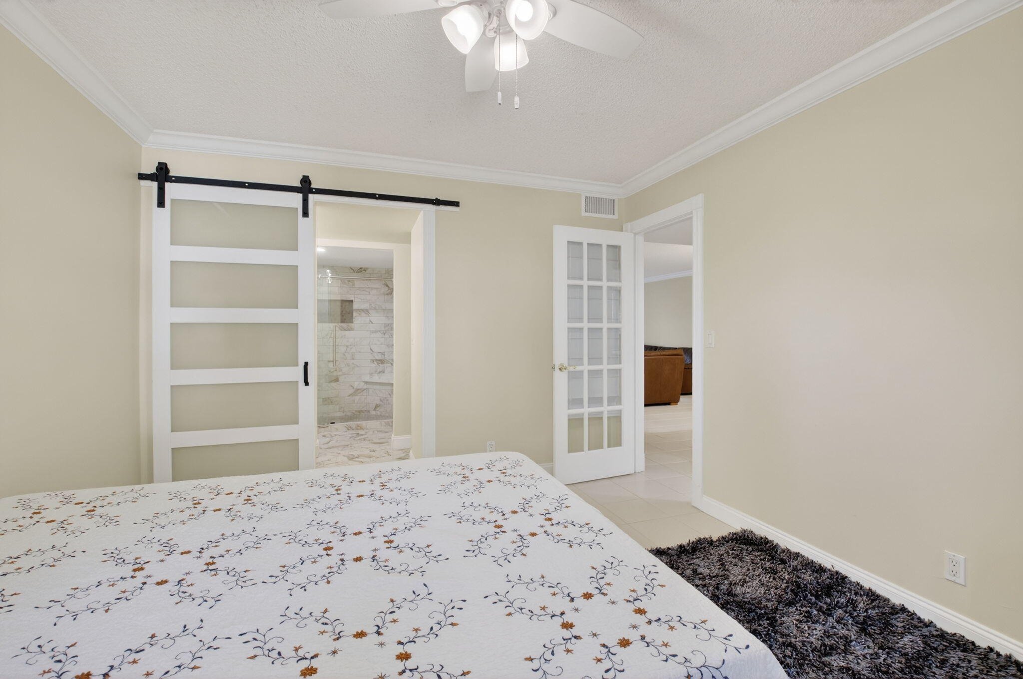 159 Northwest 70th Street, Unit 403 Boca Raton, FL 33487 - Photo 12 of 31 a bedroom with a bed and a dresser