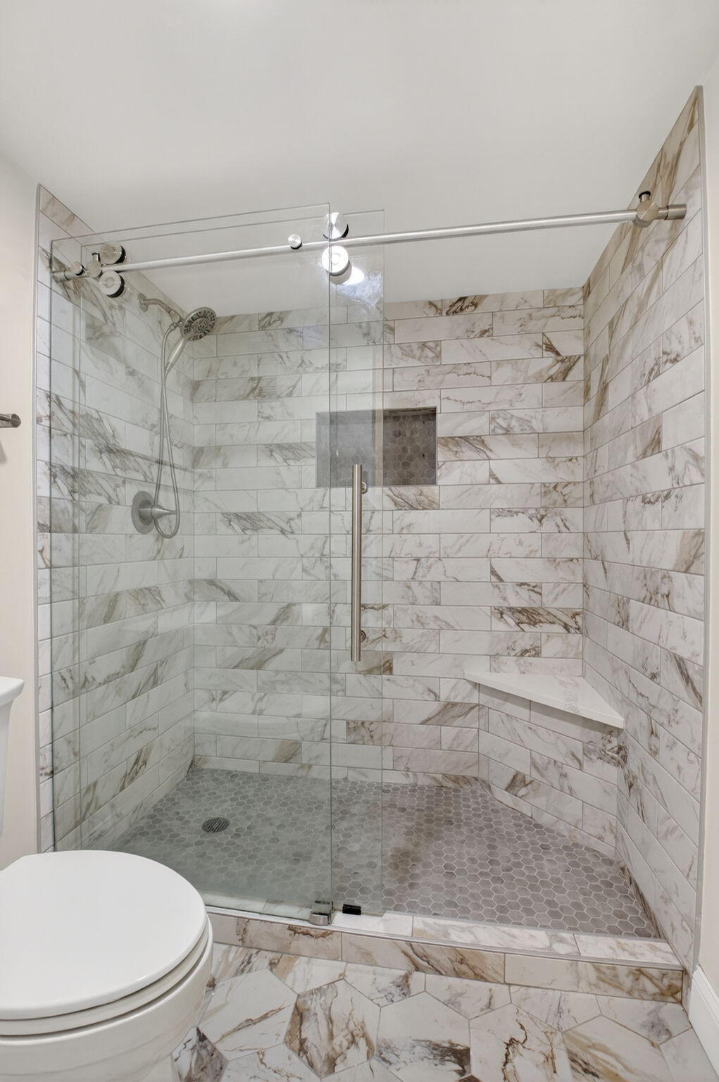 159 Northwest 70th Street, Unit 403 Boca Raton, FL 33487 - Photo 14 of 31 a bathroom with a toilet sink and shower