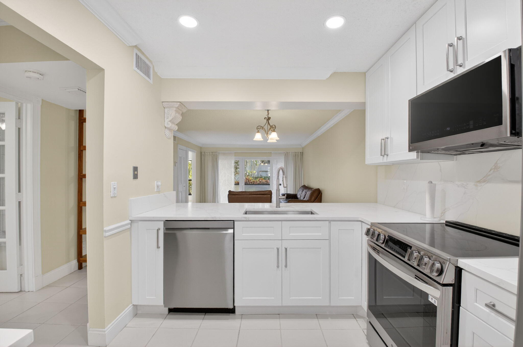 159 Northwest 70th Street, Unit 403 Boca Raton, FL 33487 - Photo 4 of 31 a kitchen with a sink stove and microwave