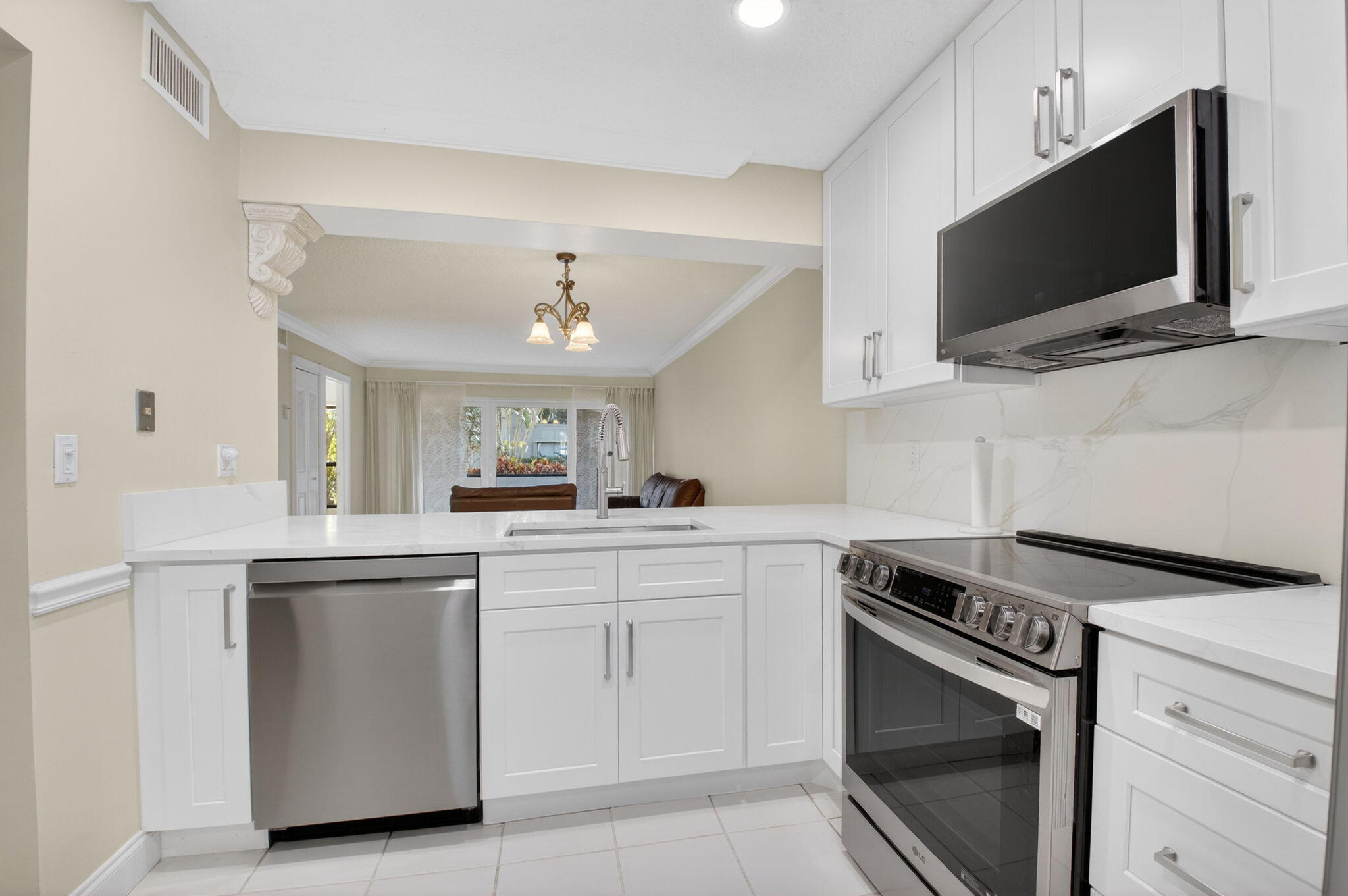 159 Northwest 70th Street, Unit 403 Boca Raton, FL 33487 - Photo 6 of 31 a kitchen with cabinets stainless steel appliances and wooden floor