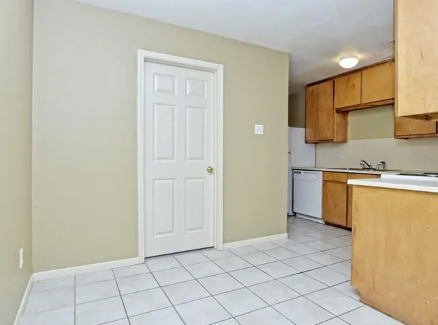 a view of a kitchen with white cabinets