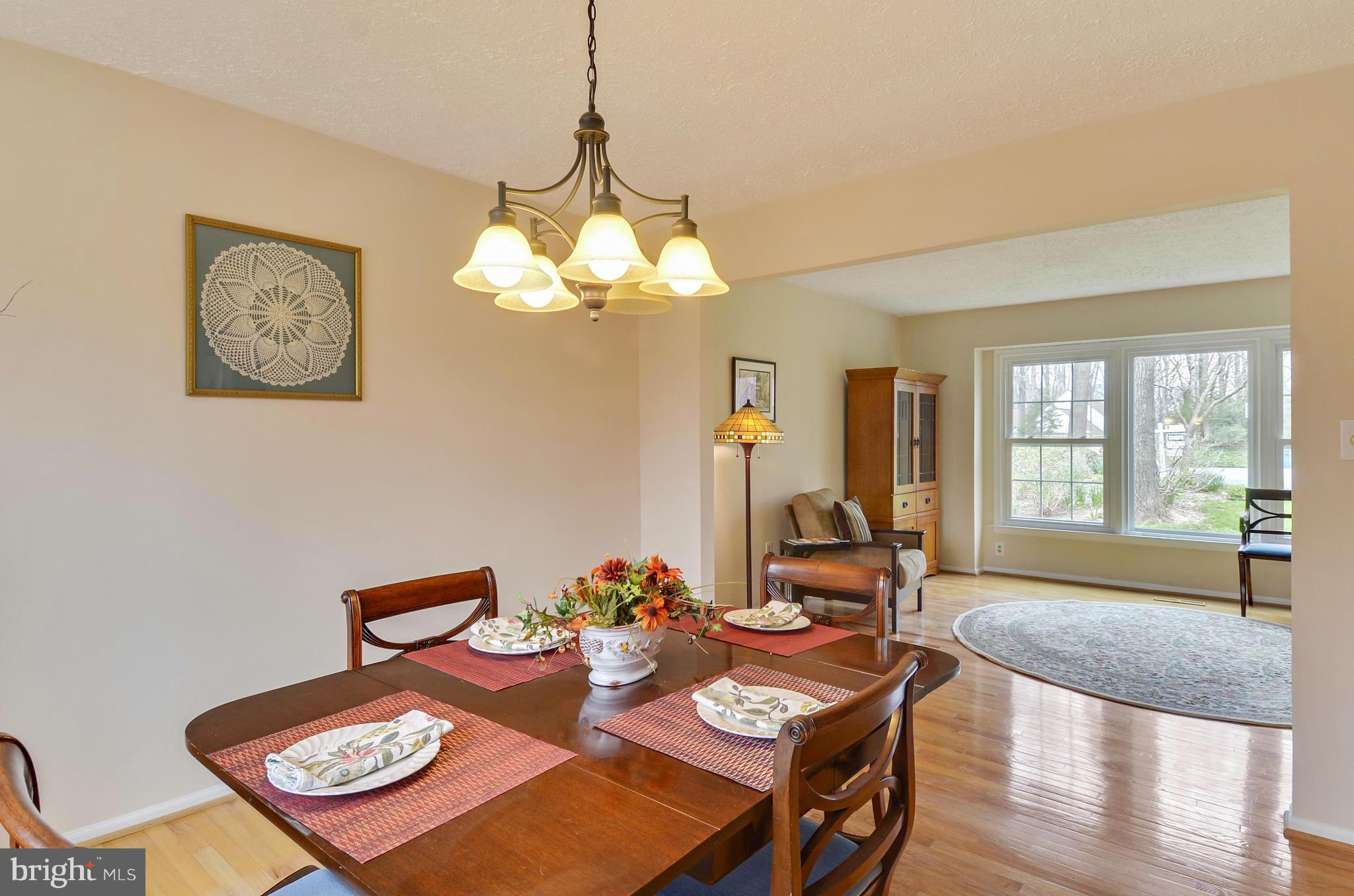 1922 Buckthorn Lane Reston, VA 20191 - Photo 14 of 30 a view of a dining room with furniture a chandelier and wooden floor