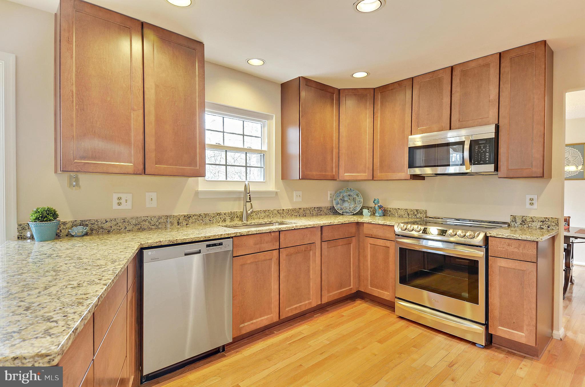 1922 Buckthorn Lane Reston, VA 20191 - Photo 7 of 30 a kitchen with stainless steel appliances granite countertop a stove a sink and a microwave