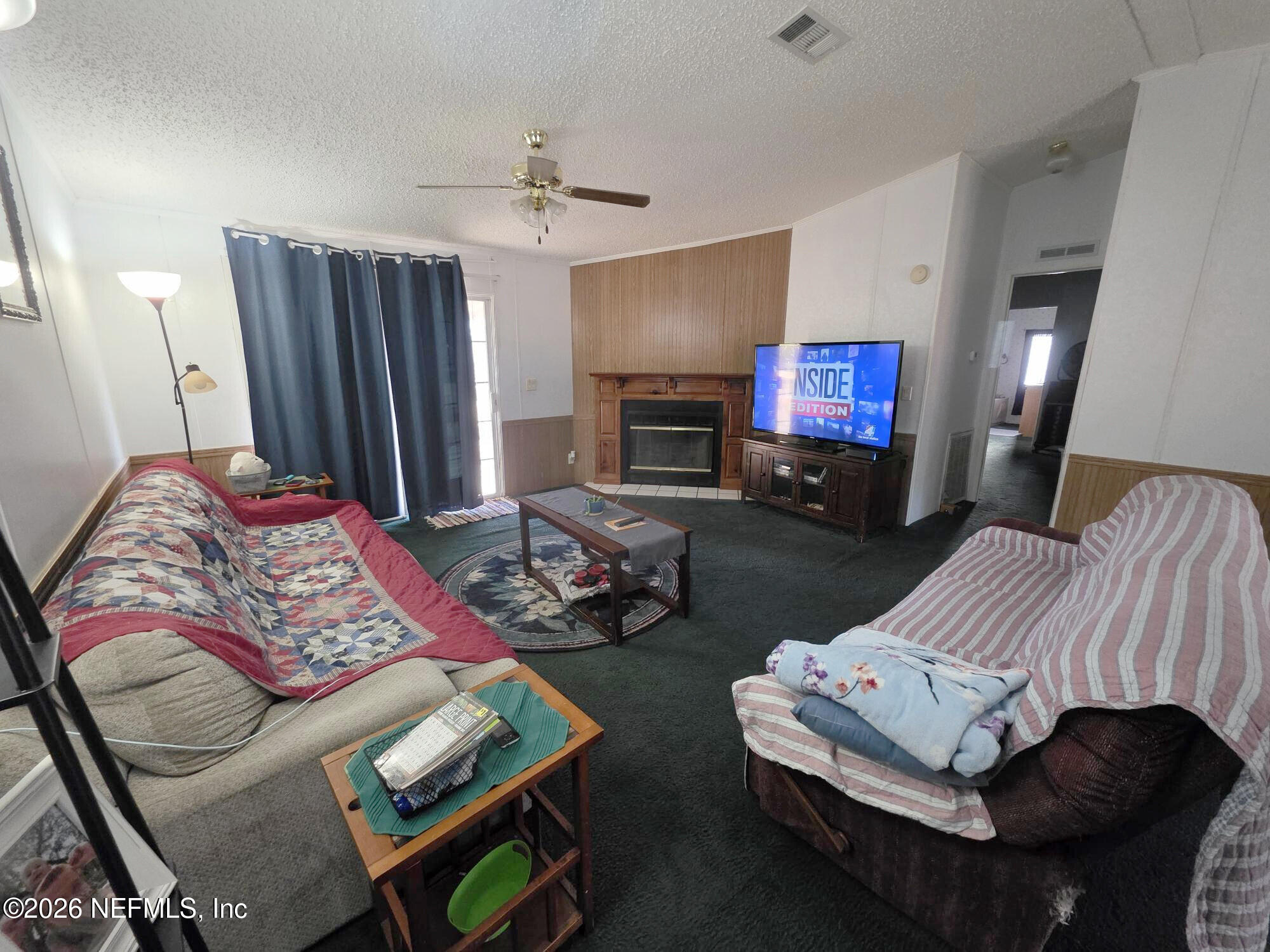 44680 Artesian Boulevard Callahan, FL 32011 - Photo 13 of 47 a living room with furniture and a flat screen tv