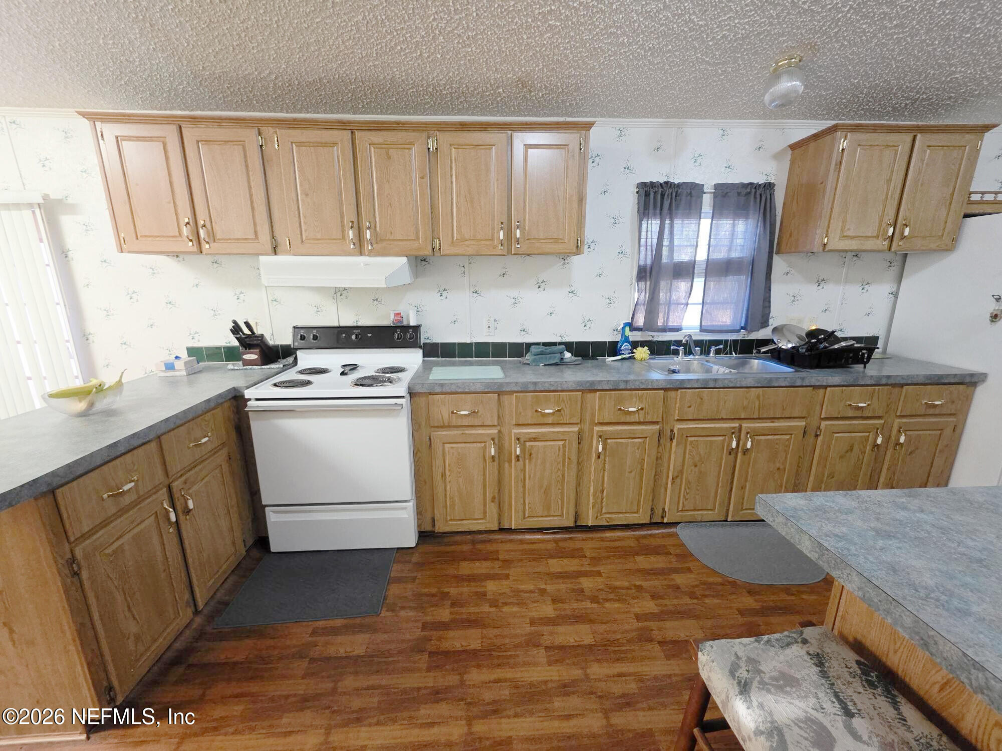 44680 Artesian Boulevard Callahan, FL 32011 - Photo 19 of 47 a kitchen with cabinets a sink and appliances