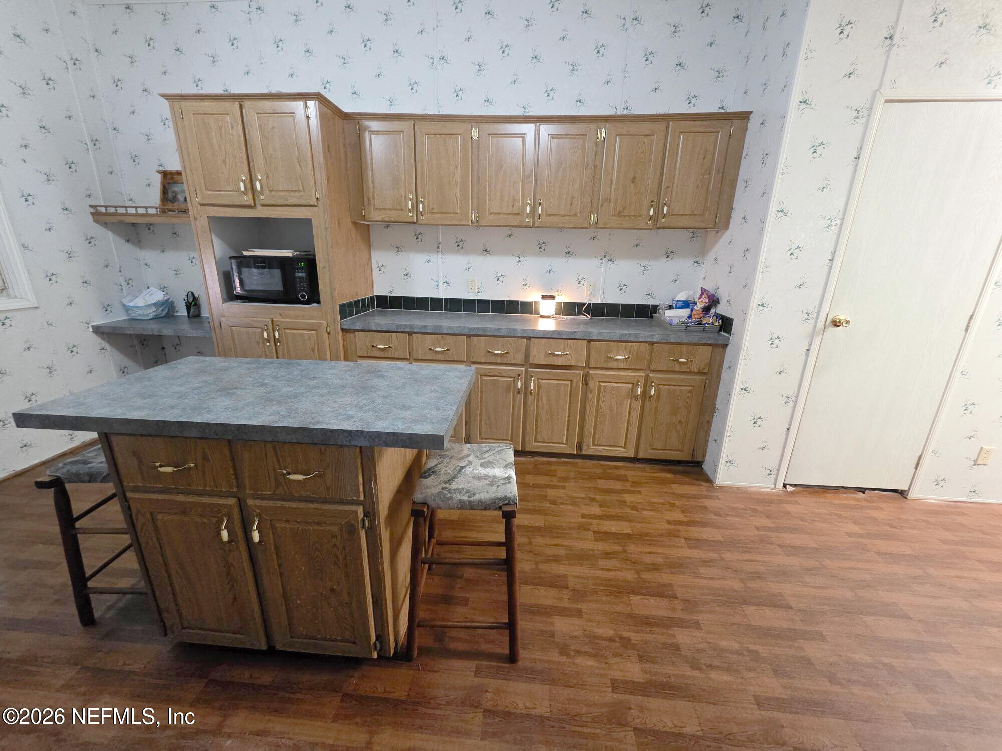 44680 Artesian Boulevard Callahan, FL 32011 - Photo 20 of 47 a kitchen with stainless steel appliances granite countertop a stove a sink and a refrigerator