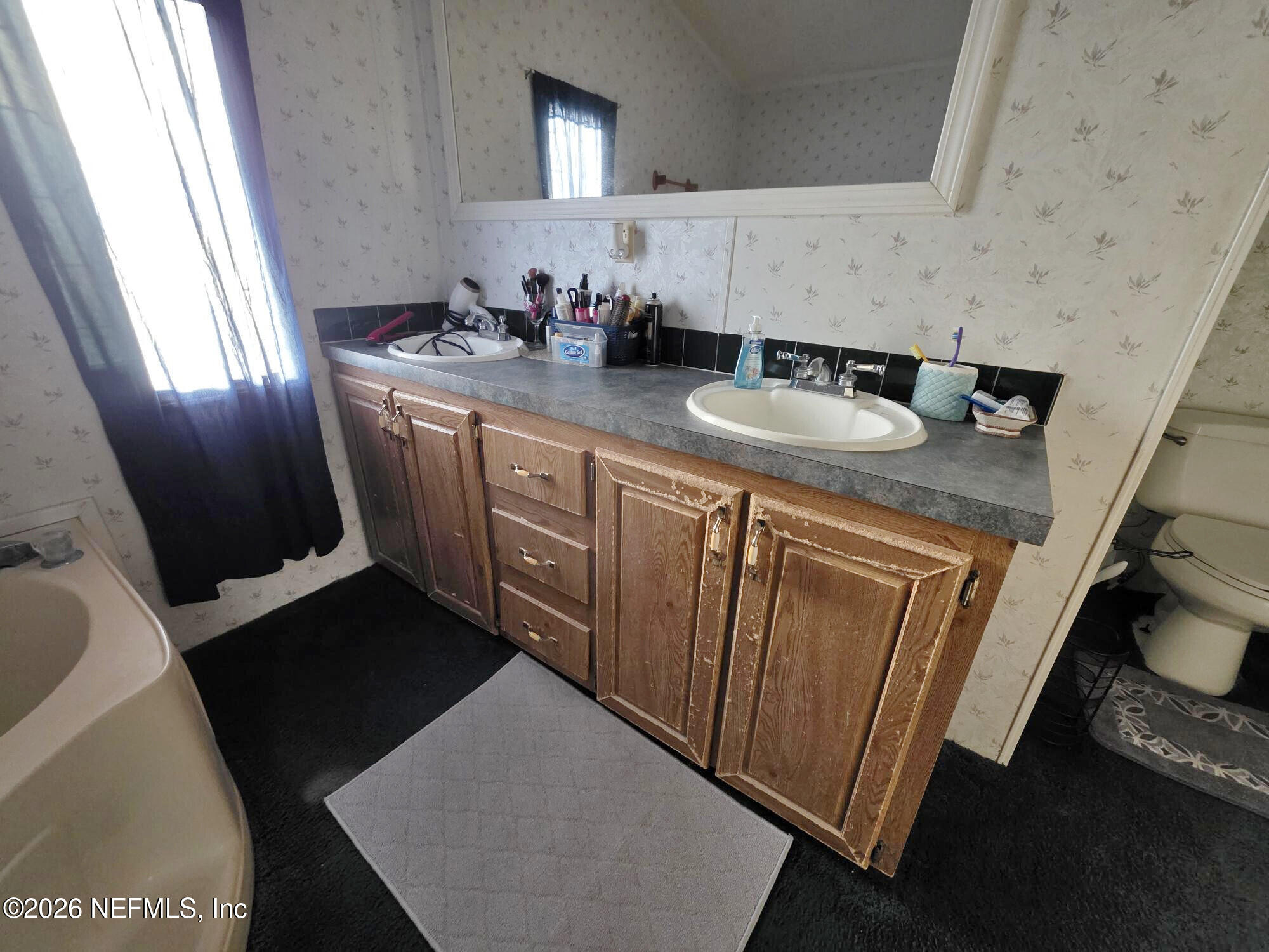44680 Artesian Boulevard Callahan, FL 32011 - Photo 29 of 47 a bathroom with sink double vanity and mirror