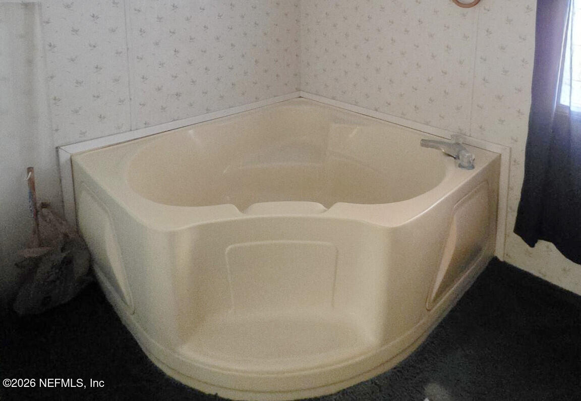 44680 Artesian Boulevard Callahan, FL 32011 - Photo 30 of 47 a white bath tub sitting in a bathroom