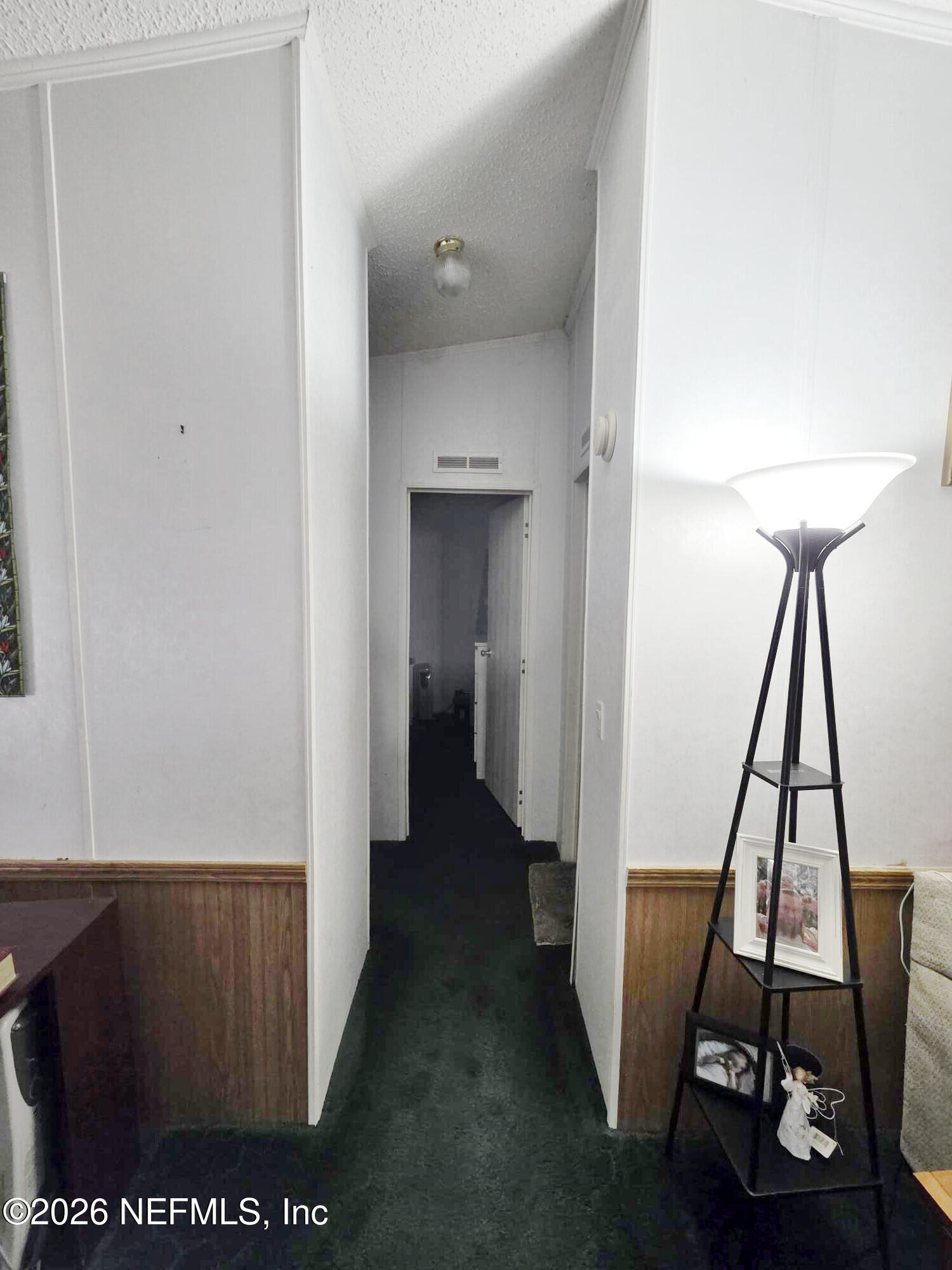 44680 Artesian Boulevard Callahan, FL 32011 - Photo 33 of 47 a view of a hallway with wooden floor and furniture