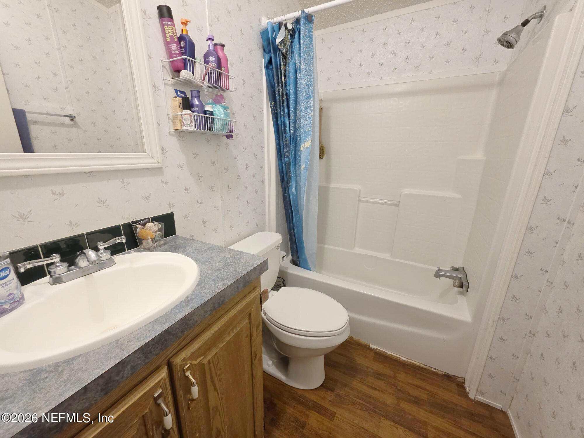 44680 Artesian Boulevard Callahan, FL 32011 - Photo 38 of 47 a bathroom with a sink toilet vanity and shower
