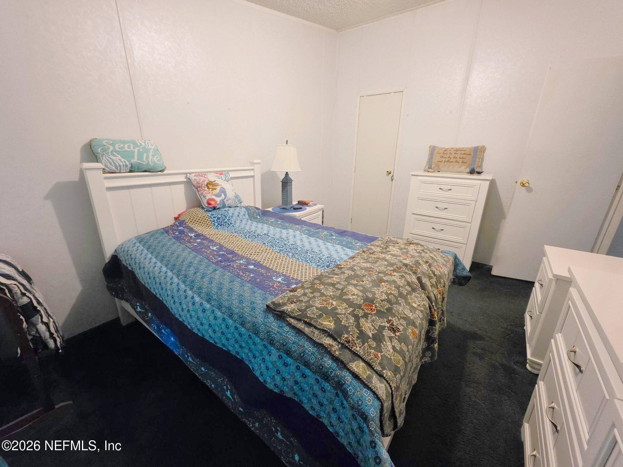 44680 Artesian Boulevard Callahan, FL 32011 - Photo 41 of 47 a bedroom with a bed and wooden floor