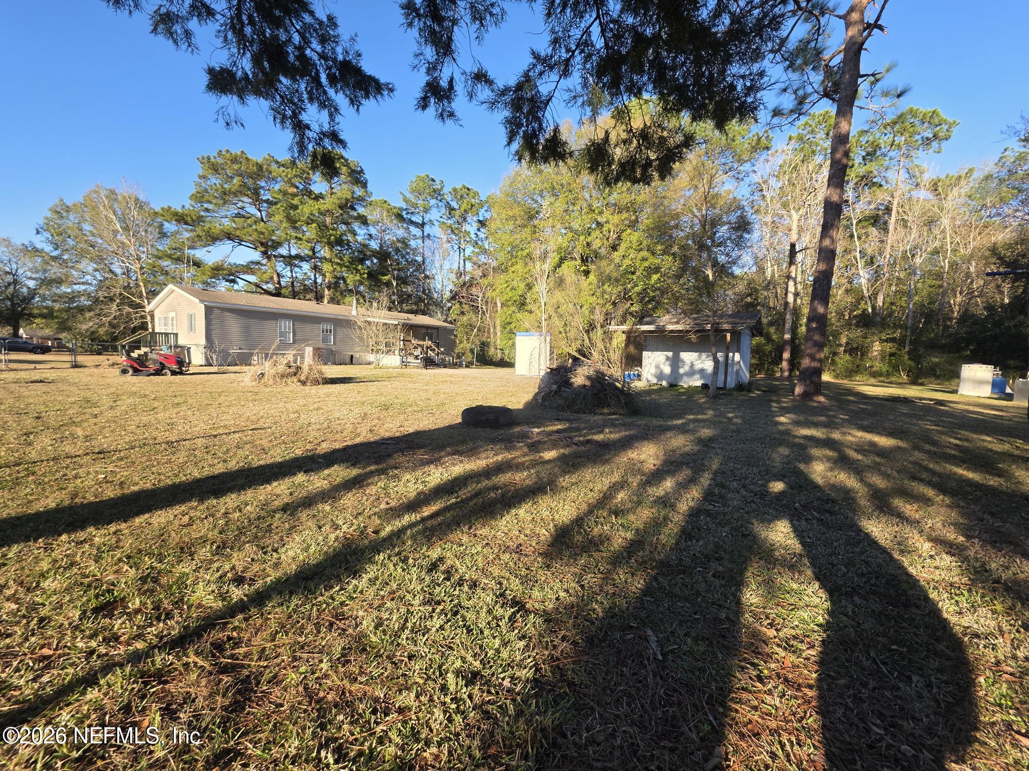 44680 Artesian Boulevard Callahan, FL 32011 - Photo 44 of 47 a view of a yard with plants and trees