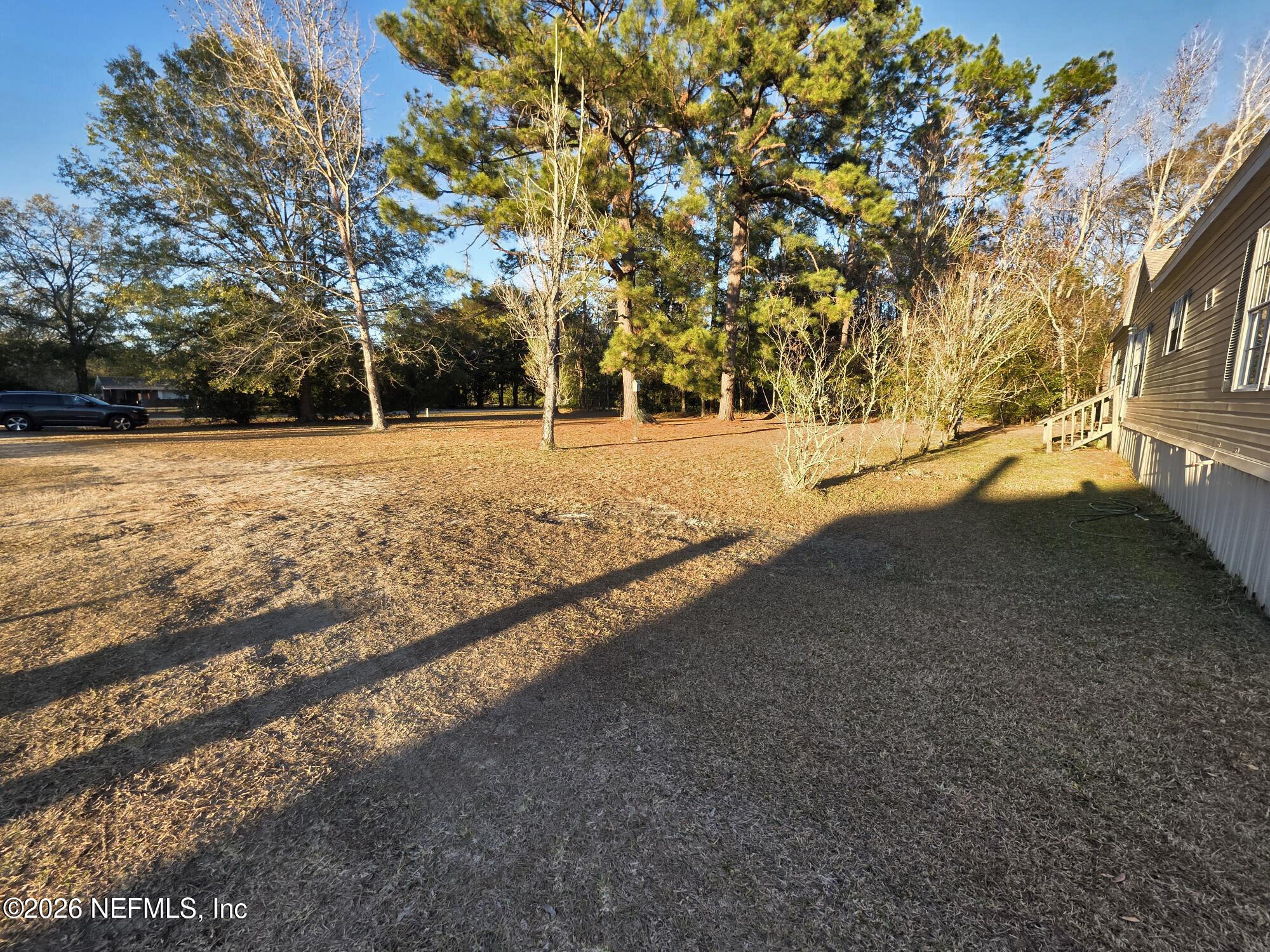 44680 Artesian Boulevard Callahan, FL 32011 - Photo 8 of 47 a view of a yard with large trees