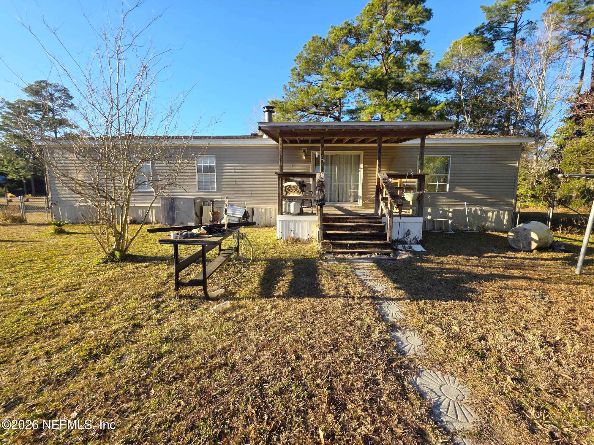 44680 Artesian Boulevard Callahan, FL 32011 - Photo 9 of 47 a view of a house with backyard porch and sitting area