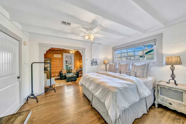 a spacious bedroom with a bed and a large window