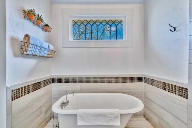 a bathroom with a bathtub and a shower