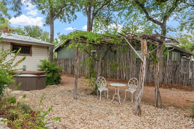 a view of a chairs and table in backyard