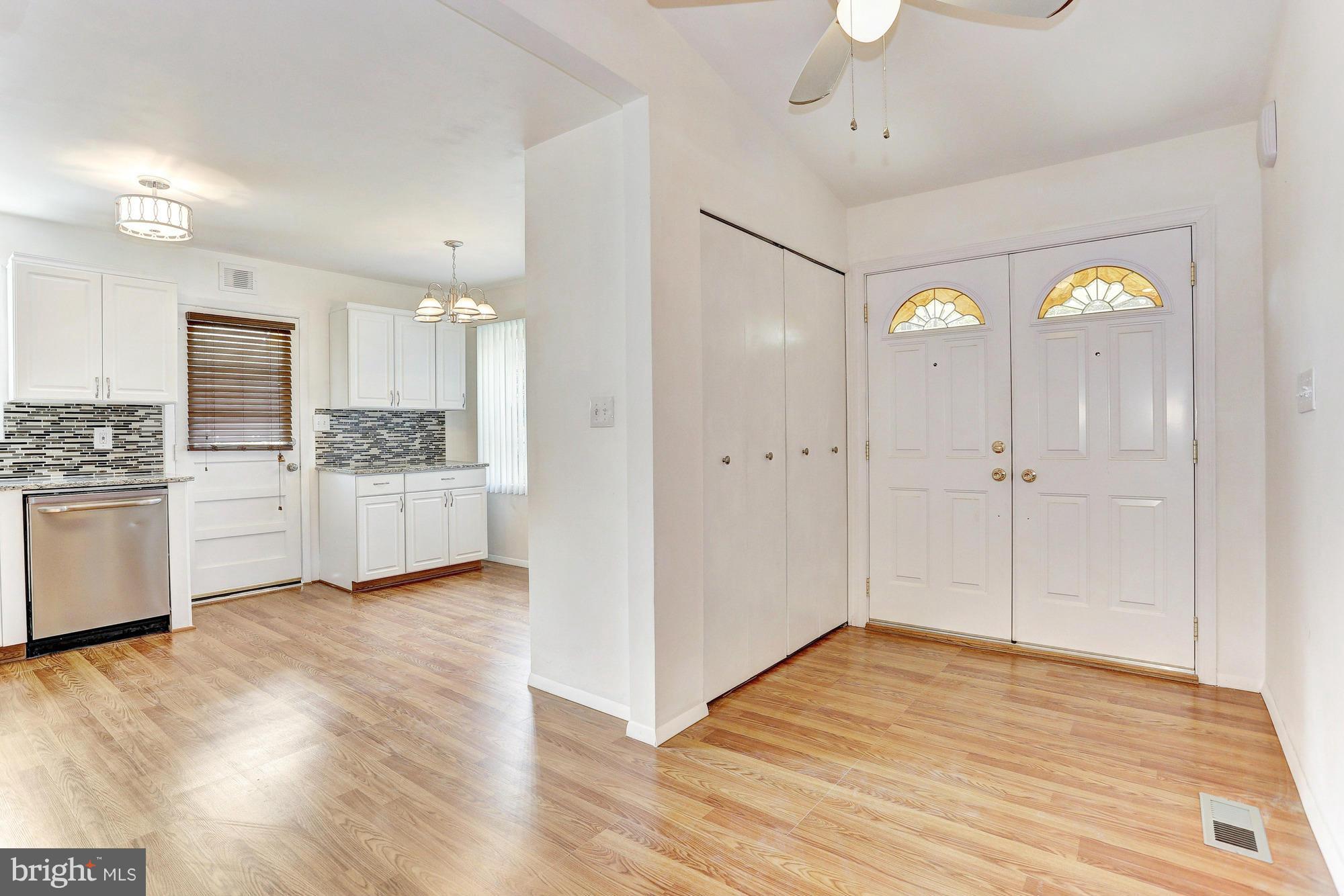 9405 Tulsemere Road Randallstown, MD 21133 - Photo 2 of 26 a view of a kitchen with wooden floor and electronic appliances