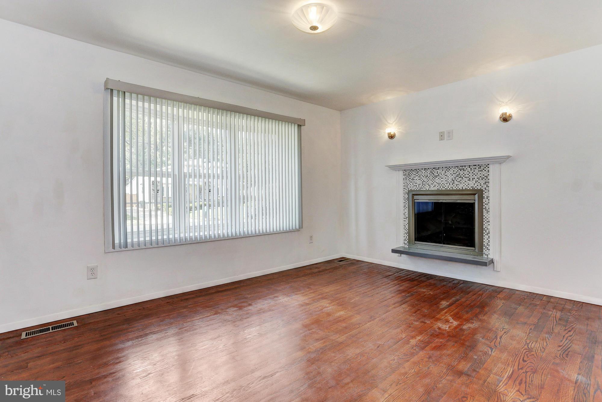 9405 Tulsemere Road Randallstown, MD 21133 - Photo 13 of 26 an empty room with windows and fireplace