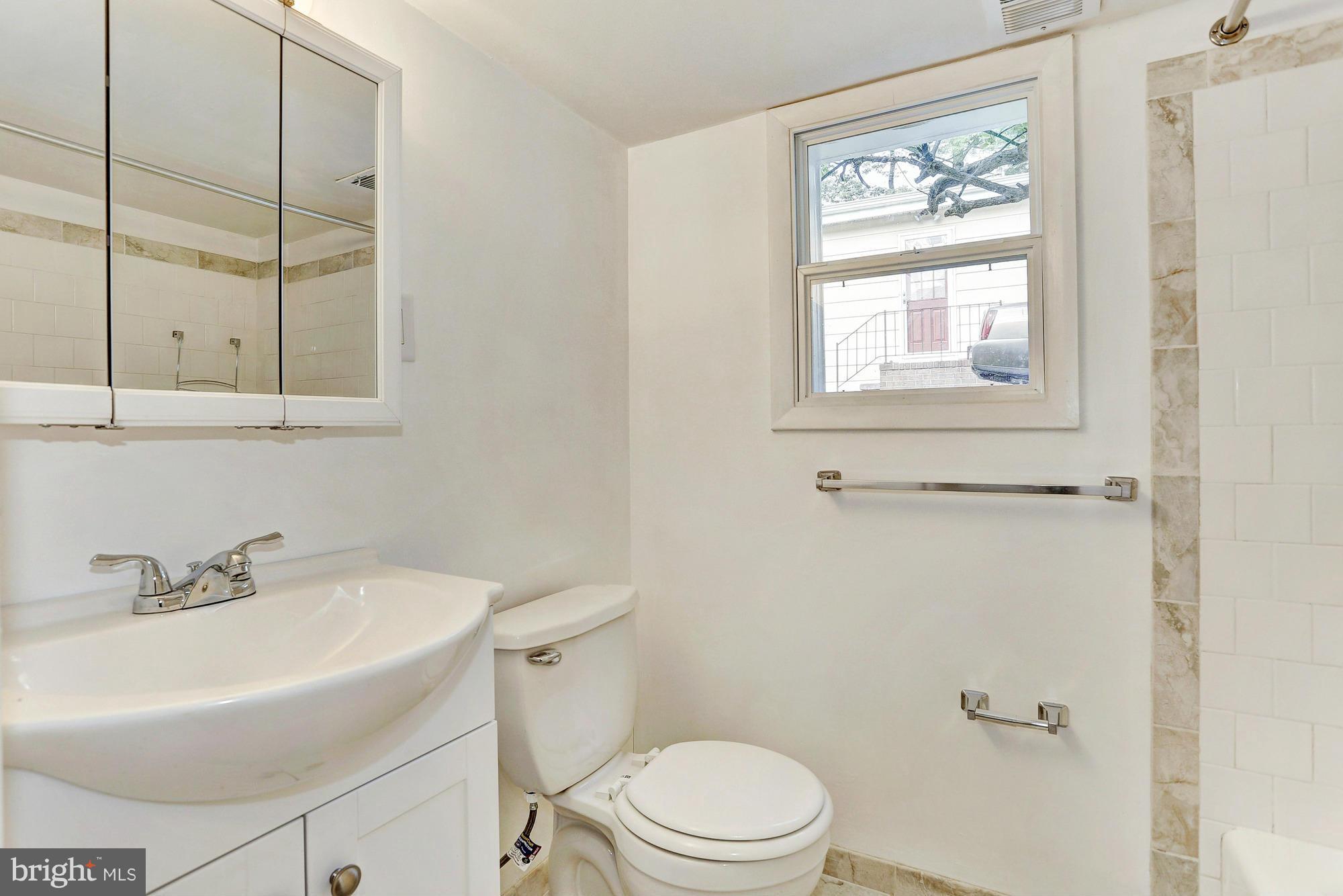 9405 Tulsemere Road Randallstown, MD 21133 - Photo 18 of 26 a bathroom with a sink a toilet and shower