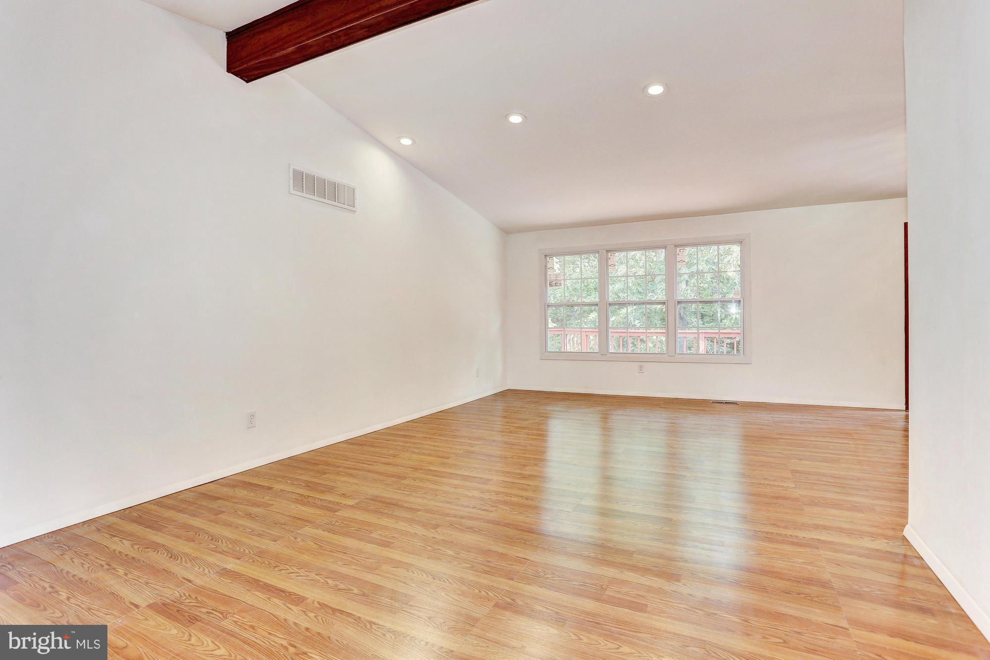 9405 Tulsemere Road Randallstown, MD 21133 - Photo 3 of 26 an empty room with wooden floor and windows