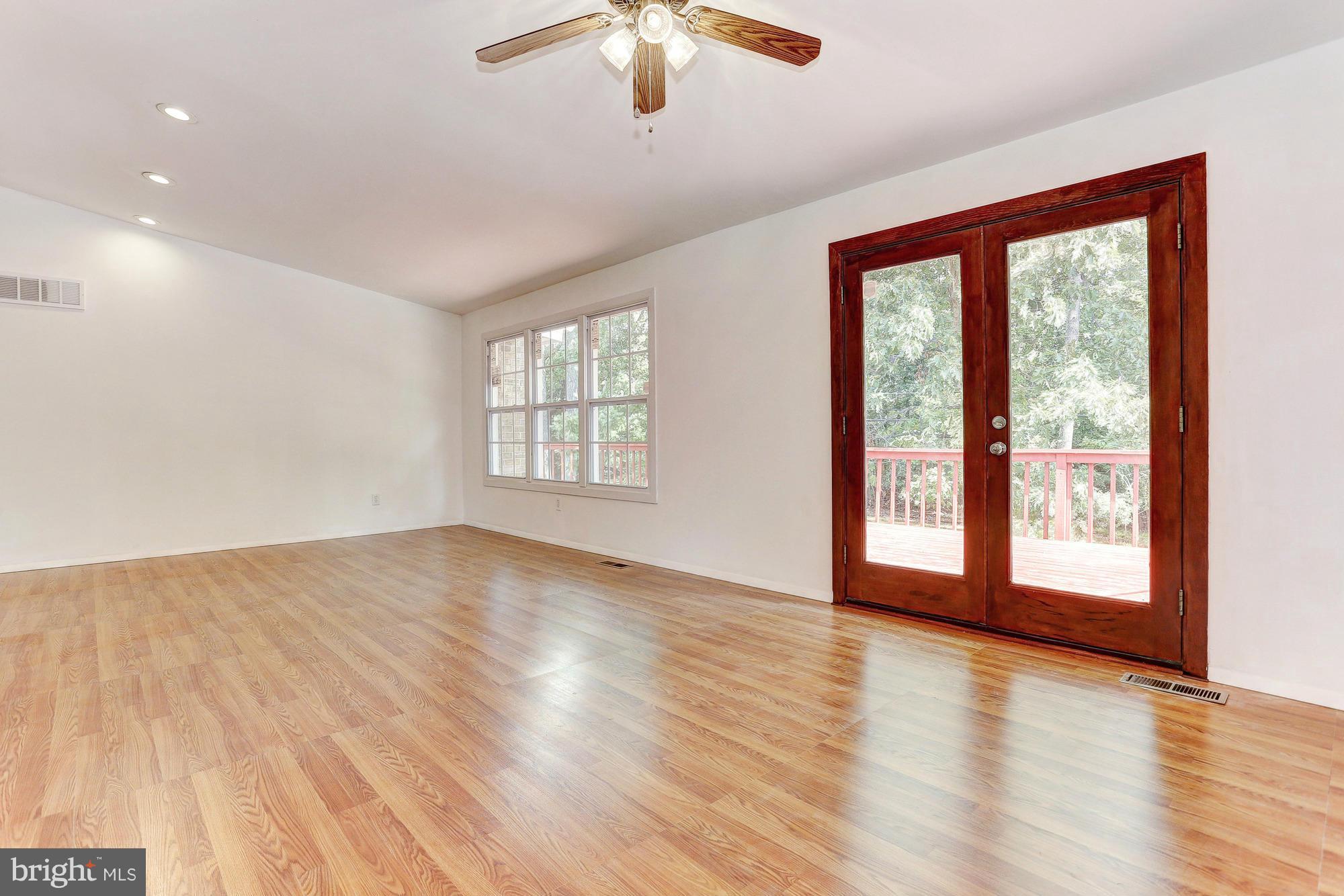 9405 Tulsemere Road Randallstown, MD 21133 - Photo 26 of 26 a view of an empty room with a window and wooden floor