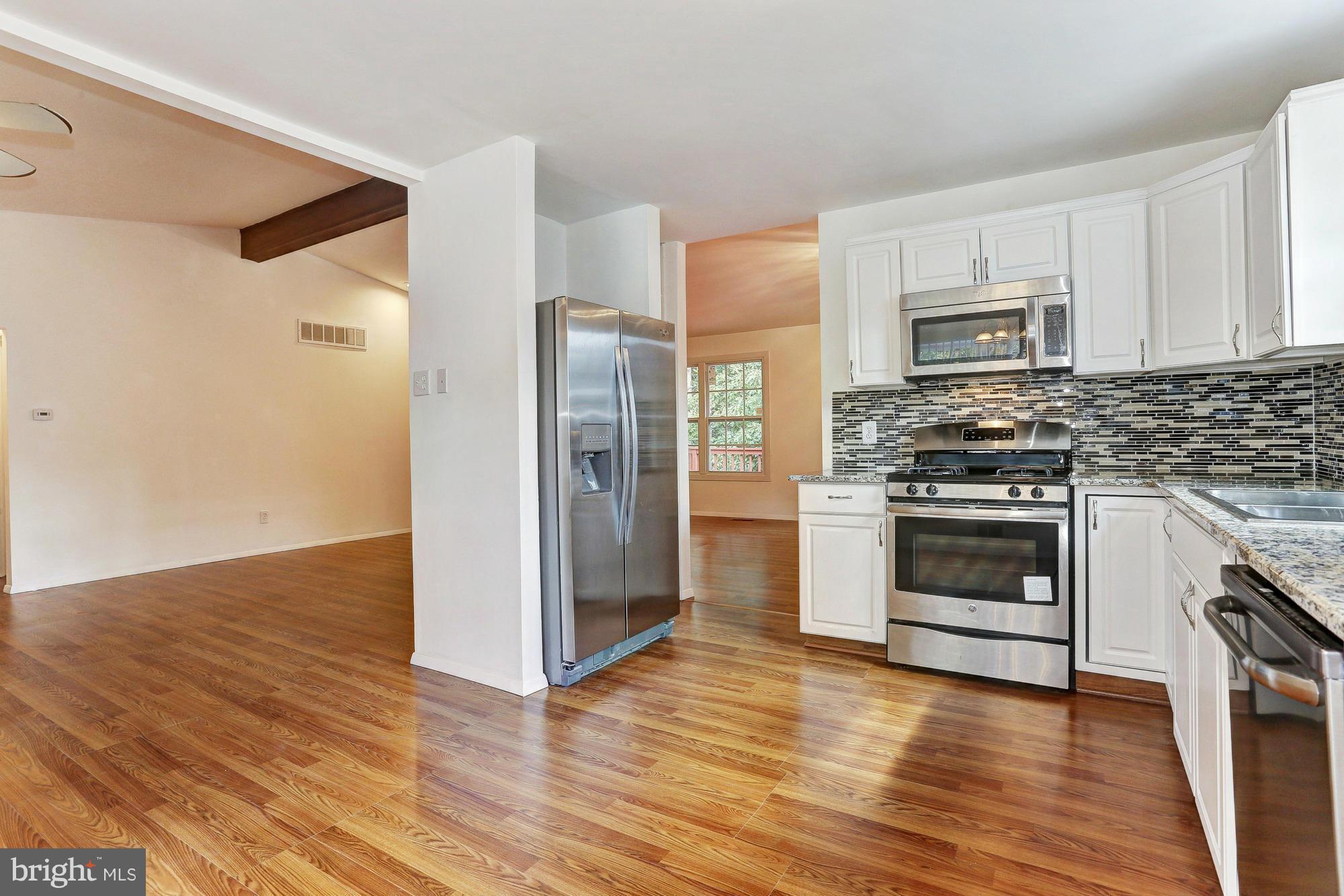 9405 Tulsemere Road Randallstown, MD 21133 - Photo 7 of 26 a kitchen with stainless steel appliances a stove a refrigerator and a microwave