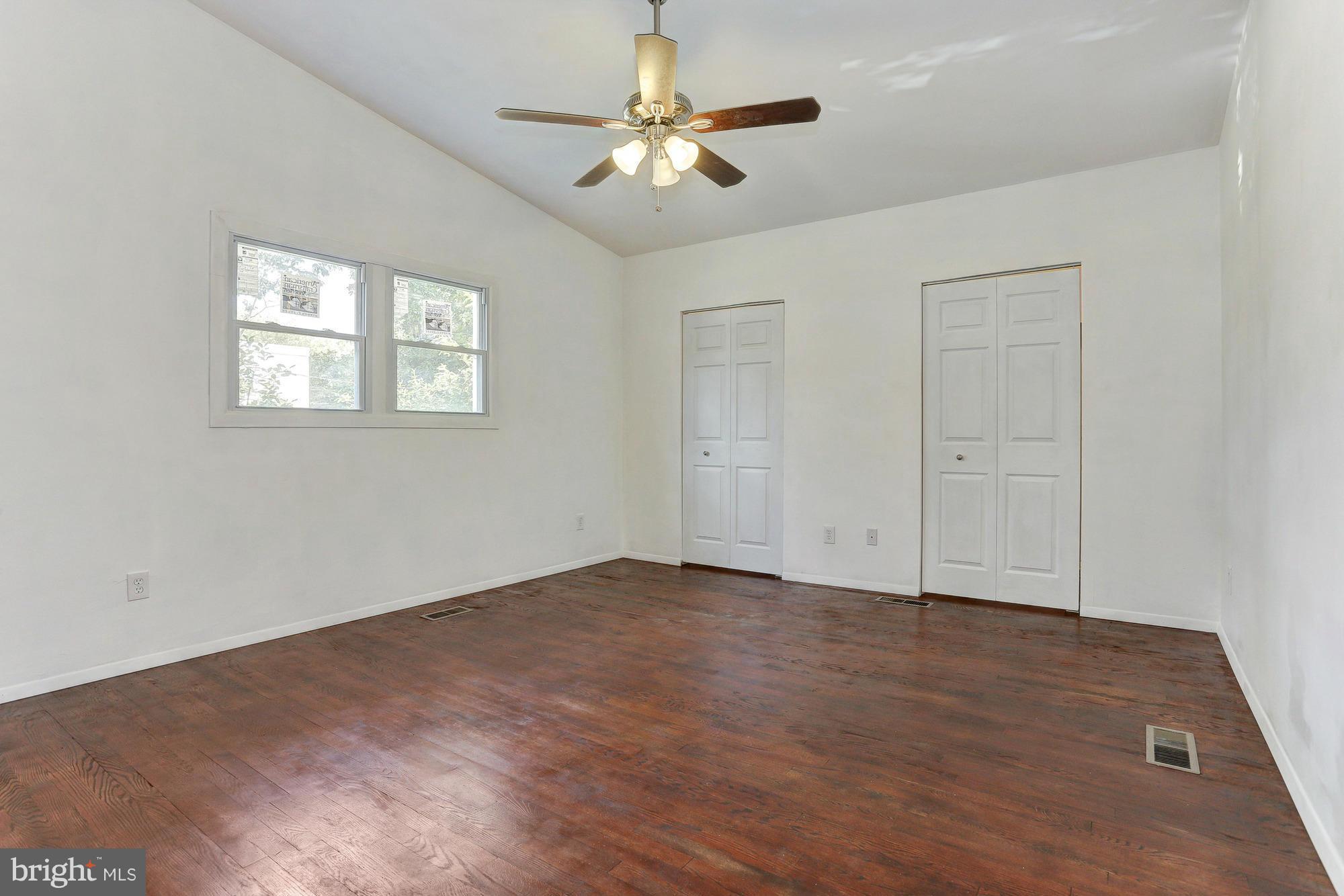 9405 Tulsemere Road Randallstown, MD 21133 - Photo 9 of 26 an empty room with fan and windows
