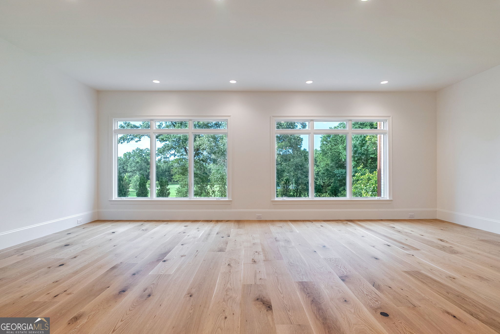 1321 Garrett Road Statham, GA 30666 - Photo 13 of 161 a view of empty room with wooden floor and fan