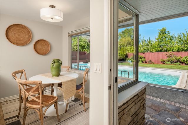 a view of a dining room with furniture and a floor to ceiling window