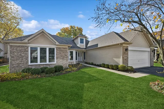 a front view of a house with a garden and plants