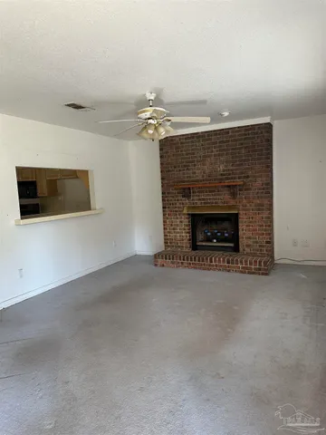 an empty room with fireplace and windows