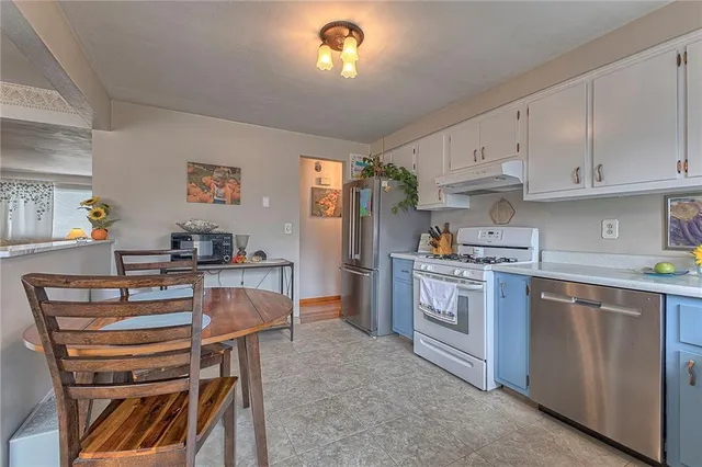 a kitchen with cabinets and appliances